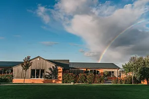 Rainbow over barns