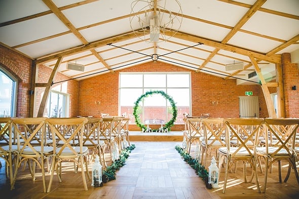 The Ceremony Room with central table and aisle lanterns