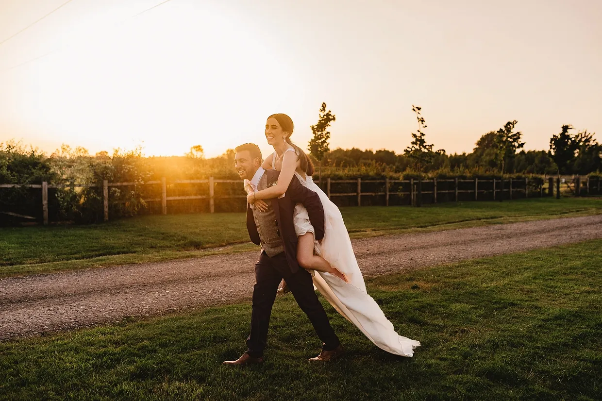 Couple in exclusive grounds during drinks reception at Warwickshire barn wedding venue