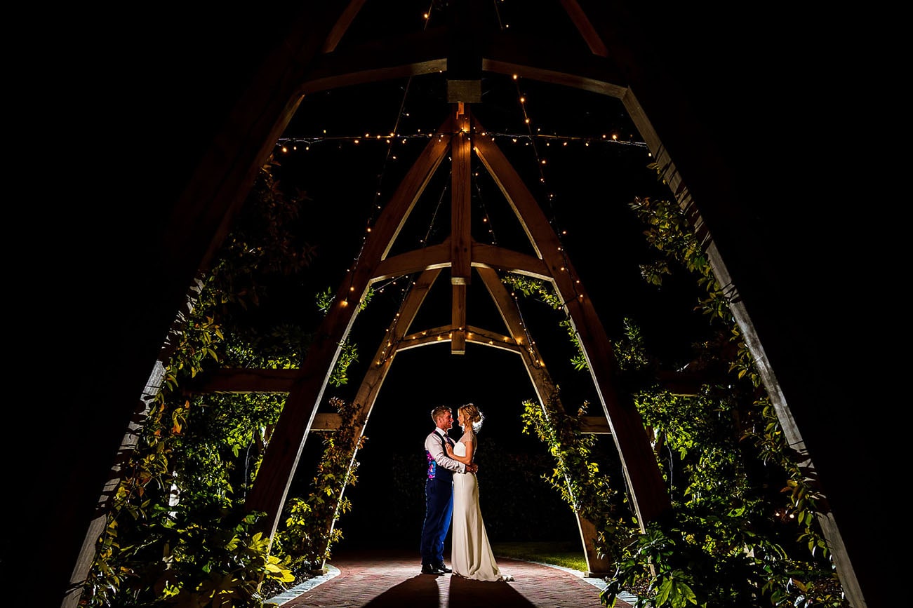 Bride and Groom under the arch at night