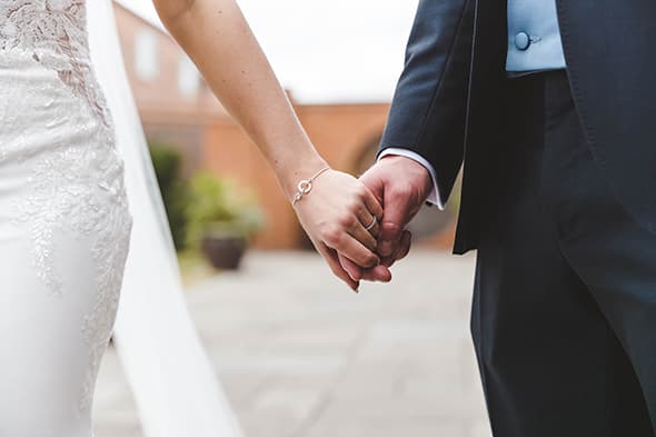 Bride and groom holding hands