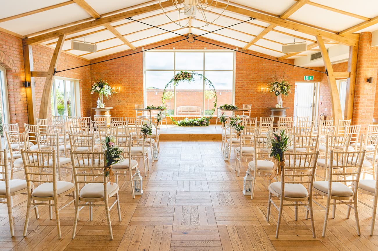 The Ceremony Room with central table and aisle lanterns