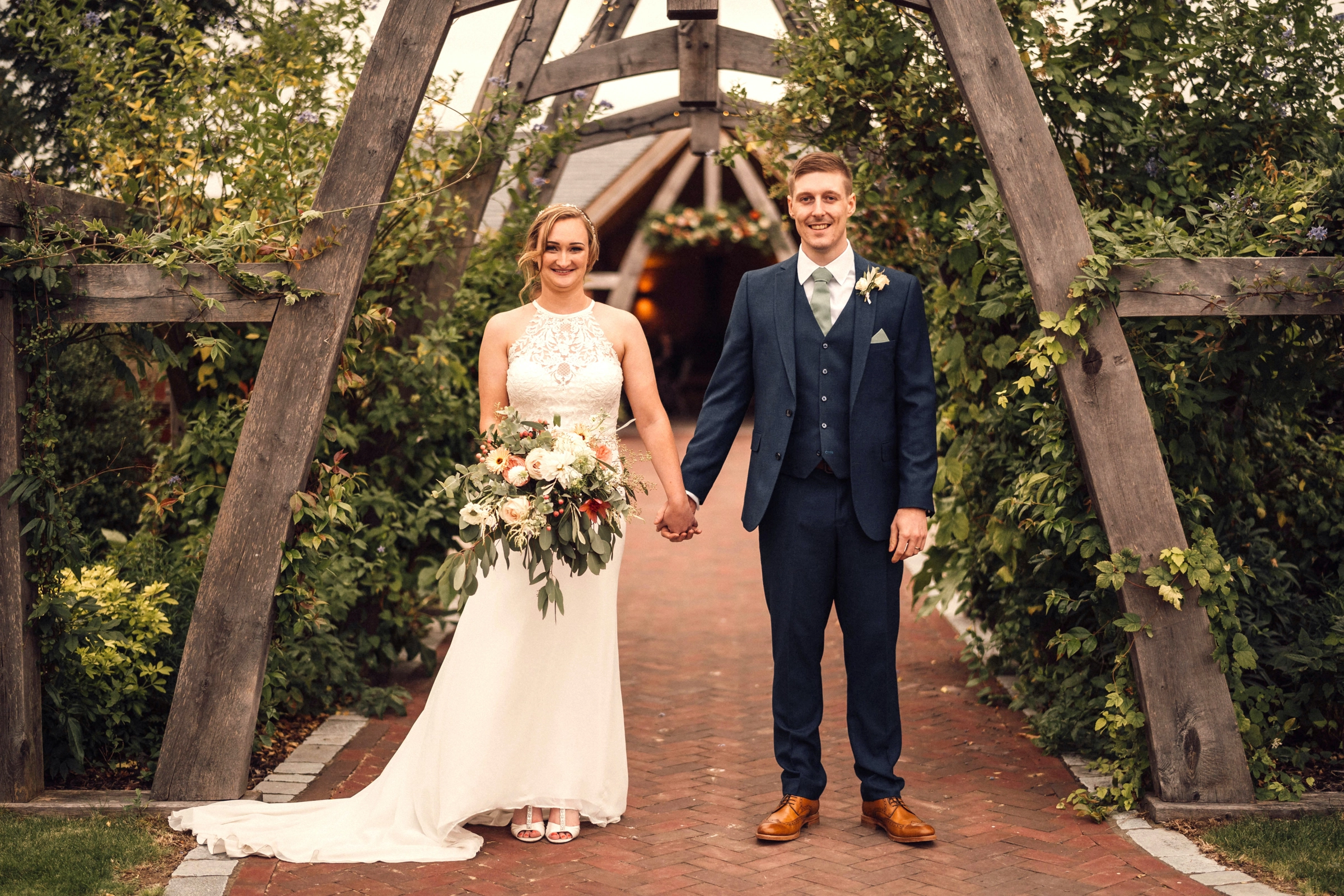 The happy couple under the entrace arch